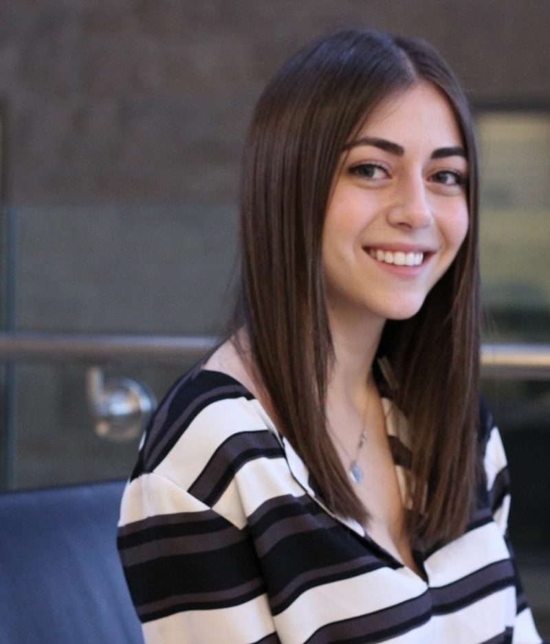 A head-shot of a young professional woman with dark brown hair and eyes.